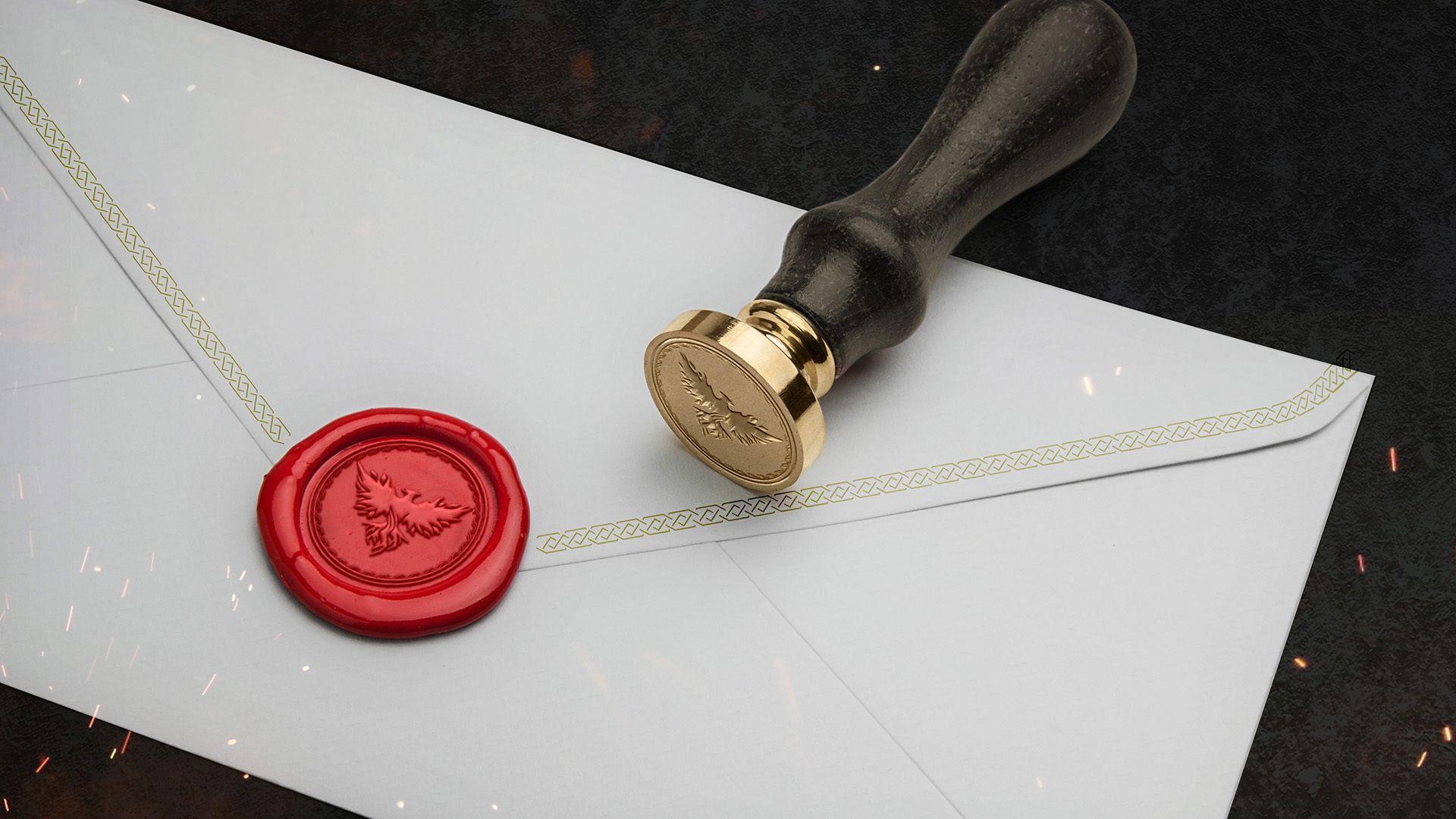 A white letter stamped with a red wax seal. The seal has the ashes phoenix in the center of it.