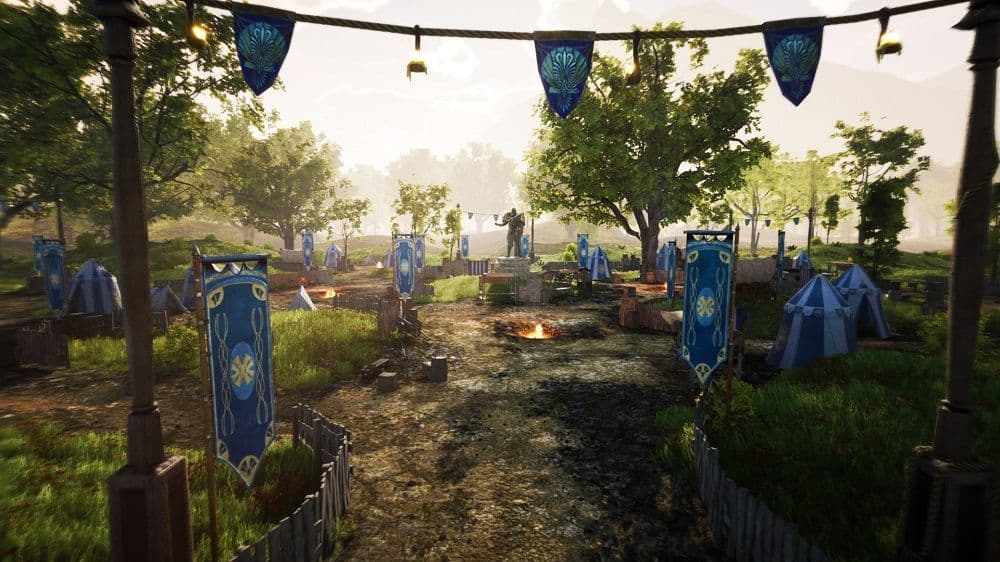 An open grassy field of a camp with blue flags planted around.